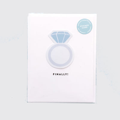wedding card that says "Finally!" with a sticker of a ring on the front